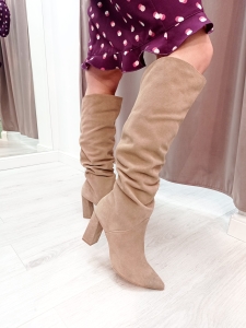 Beige suede leather boots on a post