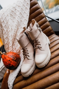 Beige leather trapper boots with ankle buckles