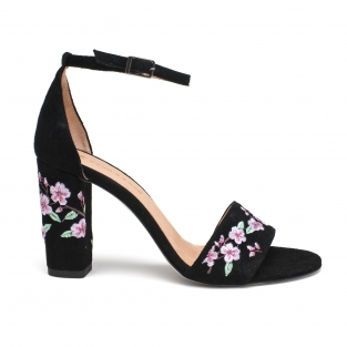Black embroidered sandals on a post